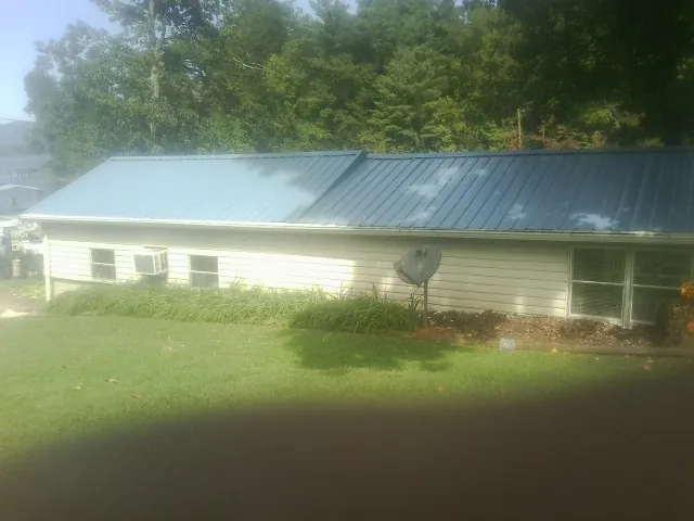 Blue metal roof running the length of a single story home in Burton